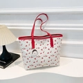 White cherry print tote bag with red leather trim and golden logo plate detail - Red