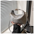 Detail of gray snakeskin pattern texture and metal buckle on faux leather bucket bag - Silver
