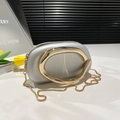 Silver mini pebble round bag with gold metal handle and elegant snake chain strap - Silver