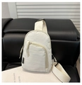 Detail of off-white crinkled nylon sling bag with adjustable strap on leather seat - White