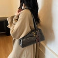 Retro black matte shoulder bag with metallic buckle and woven charm on beige coat - With Pendant / Black