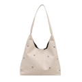 Moderne cremefarbene Hobo-Tasche aus Kunstleder mit silbernen Nieten für den täglichen Weg - Weiß