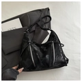 Detail view of black hobo bag with bow decoration, marble texture and silver zippers - Black