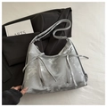 Detail showing metallic silver bow ribbons and zipper accents on smooth leather bag - Silver