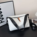 White nylon puffer shoulder bag with black adjustable strap and orange zipper detail - White