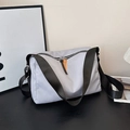 Light gray nylon pillow shoulder bag with black wide strap and contrast orange zipper pull - Gray