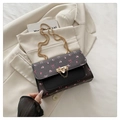 Black leather shoulder bag with pink floral and bow patterns and a gold chain strap - Black
