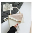 Elegant ivory white crossbody bag with beige crocodile texture and gold metal ring handle - White
