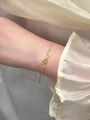 Detail of a golden snake bracelet featuring textured scales and adjustable extension chain - Snake Bracelet (Gold Plated Copper)