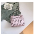 Pink tote bag with black bow patterns and white straps on denim jacket - Without Pendant / Pink