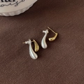 Two-tone waterdrop earrings with matte silver and polished gold finish on brown fabric - Gold and Silver Color Block Water Drop Studs