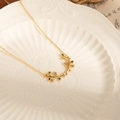 Detailed view of olive branch pendant with colorful zircon stones on a gold chain - Gold Necklace - Tri-color Zirconia (Tri-color Titanium Steel Olive Leaf Necklace)