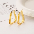 Macro view of gold irregular geometric wave hoop earrings with mirror polished finish - Gold Irregular U-Shape Ear Buckle