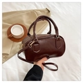 Close-up of dark brown PU leather bowling bag with twin handles and metallic zipper - Brown