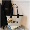 Chic beige canvas bucket bag with black leather trim and Paris print on a suitcase - With Pendant / Black