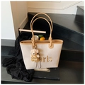 Beige canvas tote bag with brown leather trim and bear charm in a lifestyle setting - With Pendant / Khaki