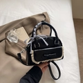 Elegant black patent leather Boston bag with lace bow detail and ribbon-wrapped handle - Black