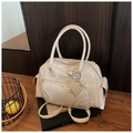 Detalle del bolso de charol crema con textura tejida y colgante de perla de corazón - Con Colgante / Blanco