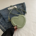 Chic light green heart-shaped crossbody bag with gold fashion text and slim strap - Green