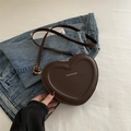 Dark brown heart-shaped crossbody bag in matte PU leather over blue denim jacket - Brown
