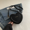 Chic black heart-shaped crossbody bag with gold text and adjustable leather strap - Black