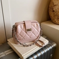 Pale pink quilted shoulder bag with silver metal clasp and chain strap on vintage props - Pink