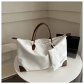 Detailed view of white nylon tote bag with brown leather handles and matching pouch - White