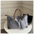Detail of grey nylon tote bag with brown leather handles and matching small pouch - Gray