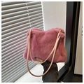 Close-up of a plush pink faux fur shoulder bag with soft texture and slim cord handles - Pink