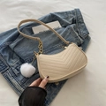 Quilted beige underarm bag featuring a gold chain and soft faux fur pompom detail - Khaki With Pendant
