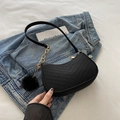 Black V-quilted hobo bag with gold chain strap and plush pompom charm on denim background - Black with Pendant