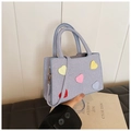 Detail of blue striped canvas bag with colorful heart patches and adjustable strap - Blue