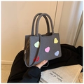 Close-up of gray woven tote bag with five colorful matte heart accents and dual handles - Black