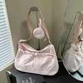 Light pink nylon crossbody bag featuring stylish pleats, drawstring design, and small coin purse - Pink