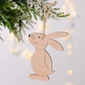 Minimalist wooden Easter bunny ornament with natural wood grain and twine on snowy tree branch - Natural Wood Color