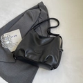 Minimalist black tote bag with textured faux leather and adjustable silver buckle strap - Black Without Charm