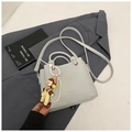 Gros plan d'un sac seau en cuir grainé avec chaîne en perles et breloque mignonne - Avec Pendentif / Bleu avec Pendentif