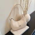 Minimalist cream crescent shoulder bag with silver bow accent and leather strap - White