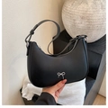 Minimalist black crescent shoulder bag with silver bow detail in matte leather finish - Black