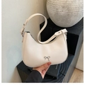 Minimalist cream white crescent shoulder bag with silver bow detail in faux leather - Antique White