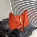 Minimalist bright orange underarm bag with gold metal clasp and chain strap detail - Orange
