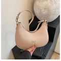Chic beige crescent hobo bag with a silver metallic bow and adjustable shoulder strap - Light Khaki