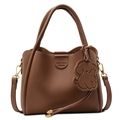 Brown bucket bag in pebbled leather with dog charm and gold-tone metal hardware - Brown