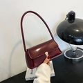 Minimalist burgundy patent leather shoulder bag with glossy finish and gold buckle - Burgundy