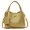 Minimalist bright yellow lychee leather bucket bag with dog charm and shoulder strap - Yellow