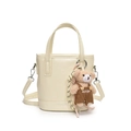 Creamy white leather bucket bag with adjustable strap and cute teddy bear pendant - Off White