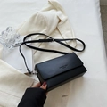 Matte black leather crossbody bag with silver buckle and adjustable strap for women - Black