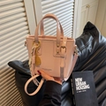 Pink fashion bucket bag with leather texture and golden spherical tassel charm - Charm / Pink