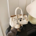 Chic off-white Kelly bag with elegant pearl strap and gold heart pendant detail - Heart Charm Style / Off White