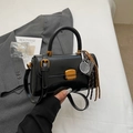 Glossy black retro handbag with gold square clasp and stylish charms in an elegant setting - Black